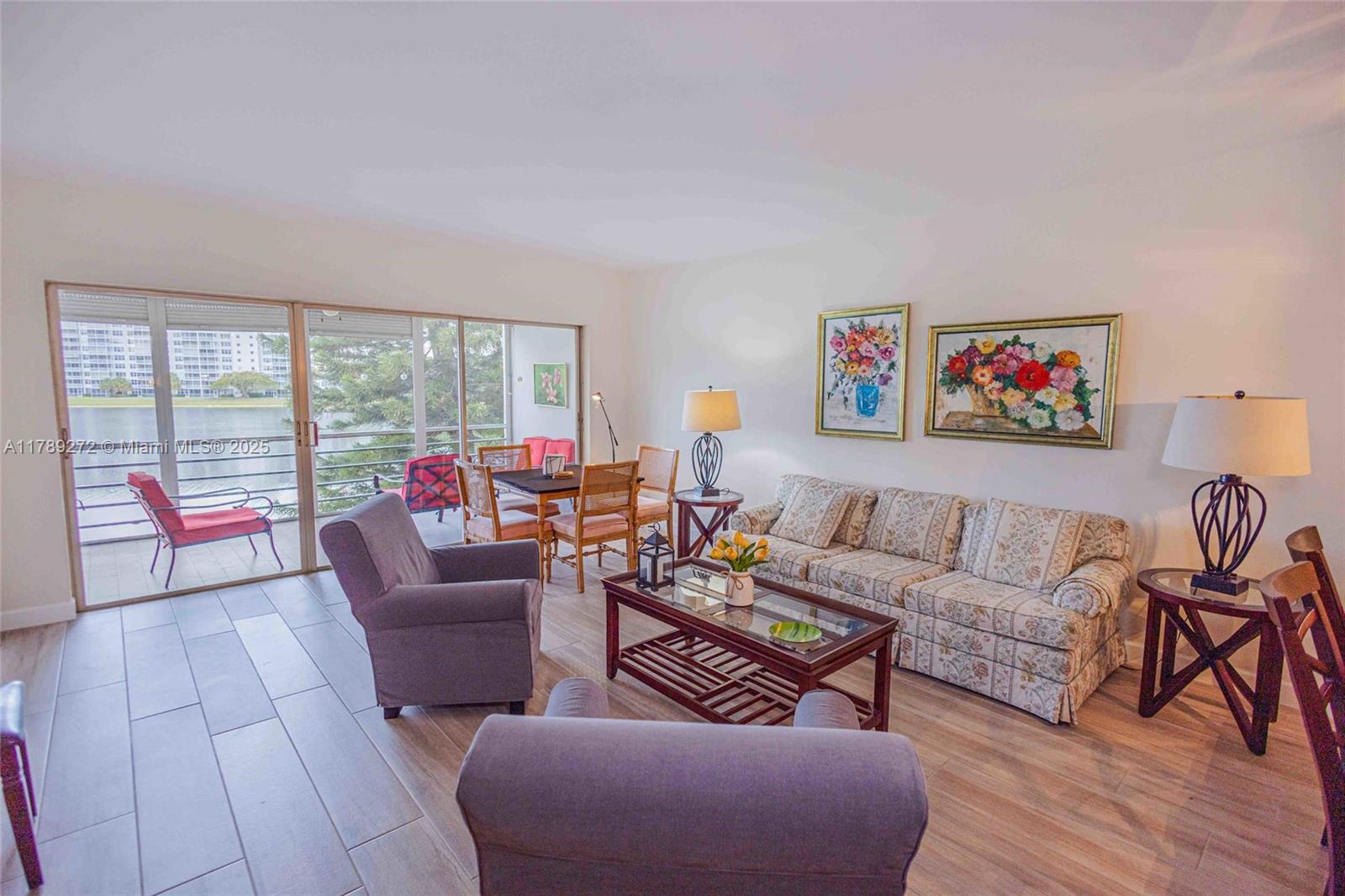2751 North Palm Aire Drive, Unit 310 Pompano Beach, FL 33069 - Photo 5 of 70 a living room with furniture and a floor to ceiling window