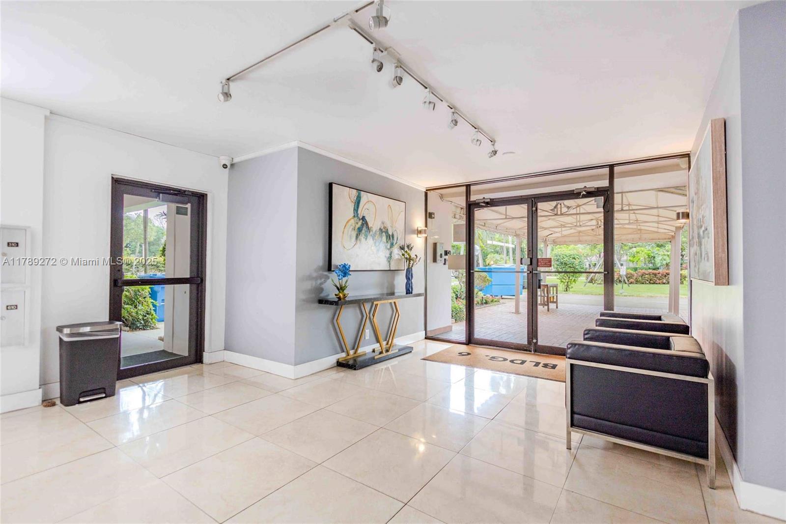 2751 North Palm Aire Drive, Unit 310 Pompano Beach, FL 33069 - Photo 54 of 70 a living room with furniture and floor to ceiling windows