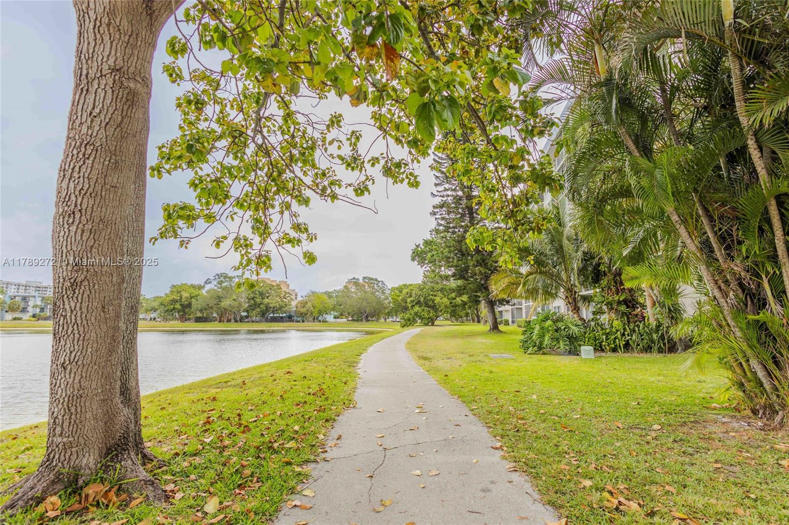 2751 North Palm Aire Drive, Unit 310 Pompano Beach, FL 33069 - Photo 61 of 70 a view of a lake with a big yard