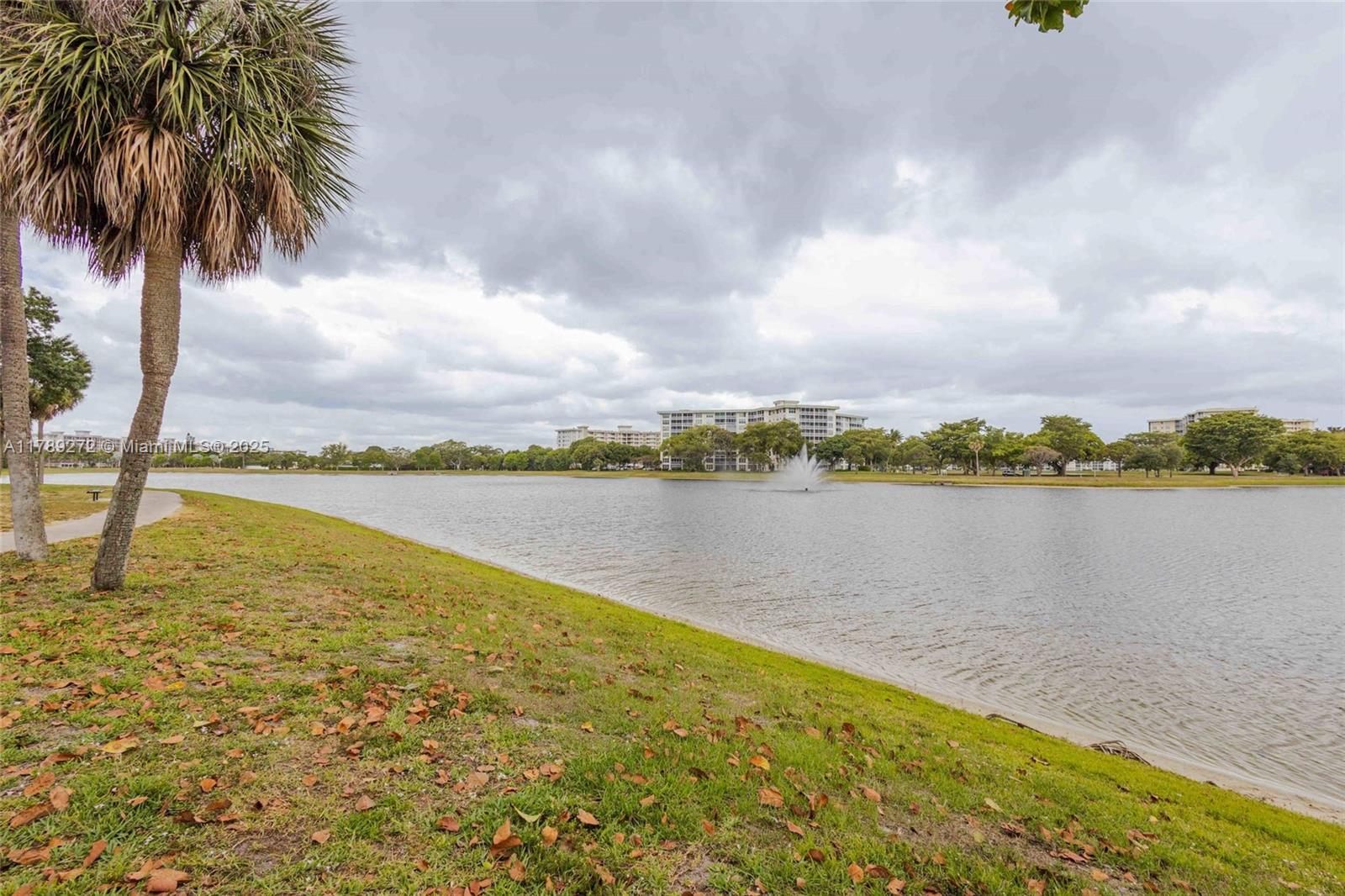 2751 North Palm Aire Drive, Unit 310 Pompano Beach, FL 33069 - Photo 63 of 70 a view of a lake with a city