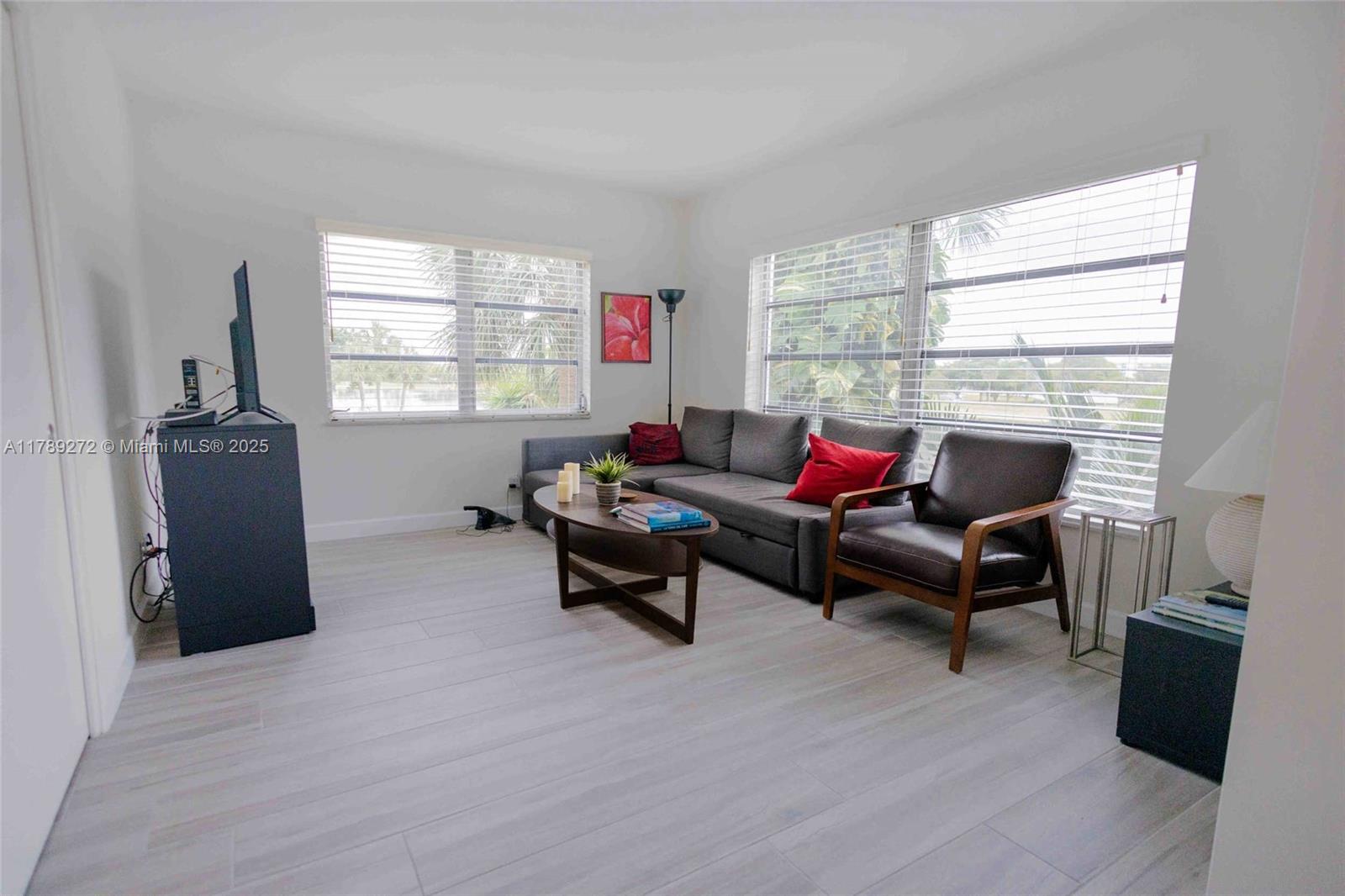 2751 North Palm Aire Drive, Unit 310 Pompano Beach, FL 33069 - Photo 8 of 70 a living room with furniture and a window