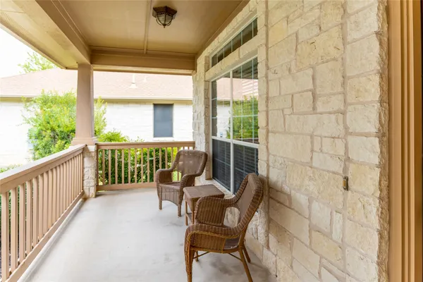 a view of a chair and tables in the balcony