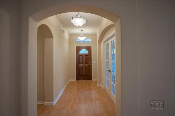 a view of a hallway with wooden floor
