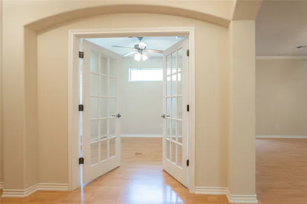 a view of a hallway with wooden floor
