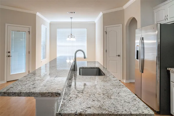a kitchen with a refrigerator and a sink