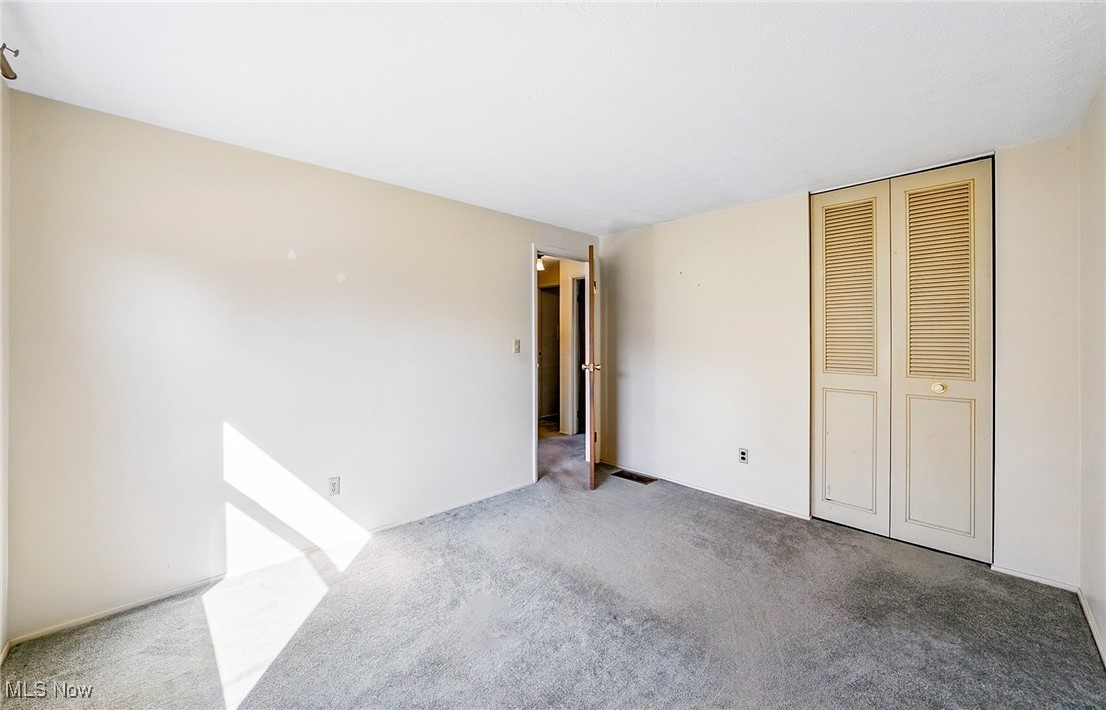 803 Renninger Road Akron, OH 44319 - Photo 29 of 44 Unfurnished bedroom featuring a closet and carpet