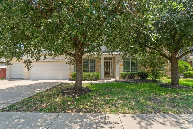 a front view of a house with a yard and garage