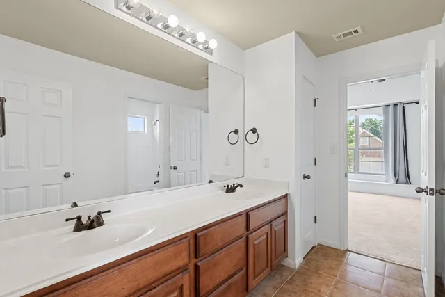 a bathroom with a sink double vanity and a mirror
