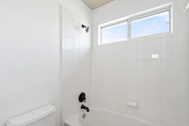 a bathroom with a toilet and shower