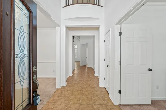 a view of a hallway with wooden floor and closet