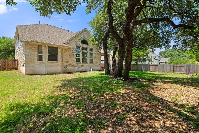 a view of house with backyard