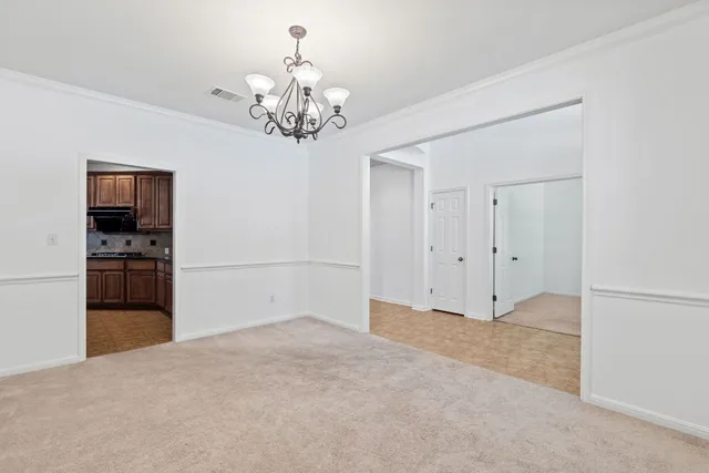 a view of a livingroom with a chandelier fan