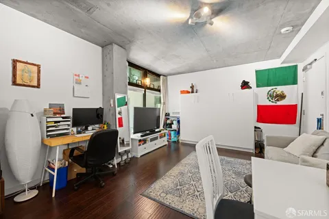 a view of a workspace with furniture and a window