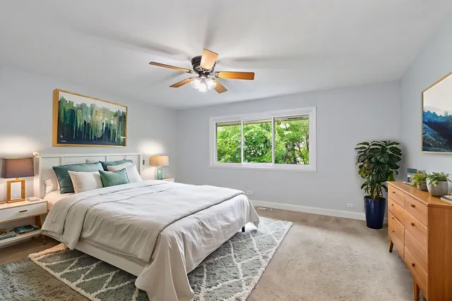 a bedroom with a bed and a potted plant