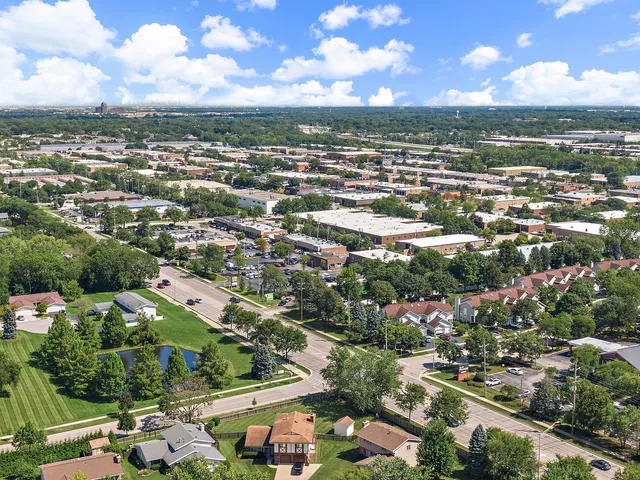 an aerial view of residential houses with city view