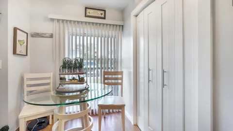a dining room with furniture and a window