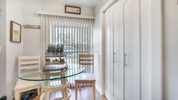 a dining room with furniture and a window