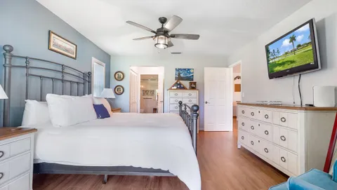 a bedroom with a bed and a flat screen tv