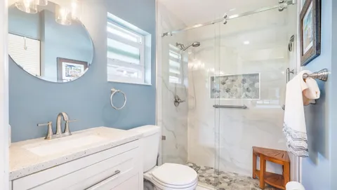 a bathroom with a sink toilet and shower
