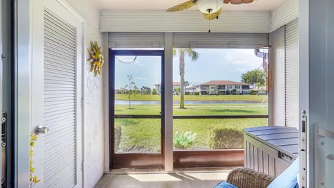 a view of a room that has a bed and glass door