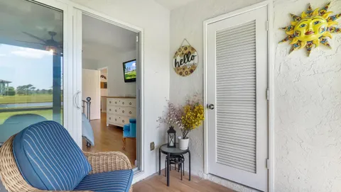 a view of a hallway with dining room and livingroom with furniture