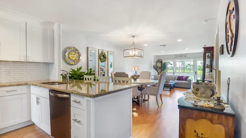 a kitchen with a dining table cabinets appliances and a counter top space
