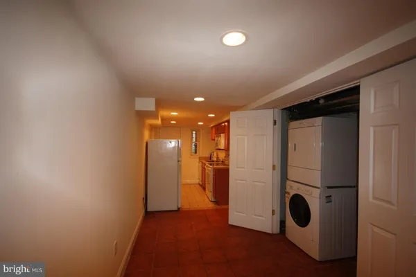 a kitchen with kitchen island granite countertop cabinets and refrigerator