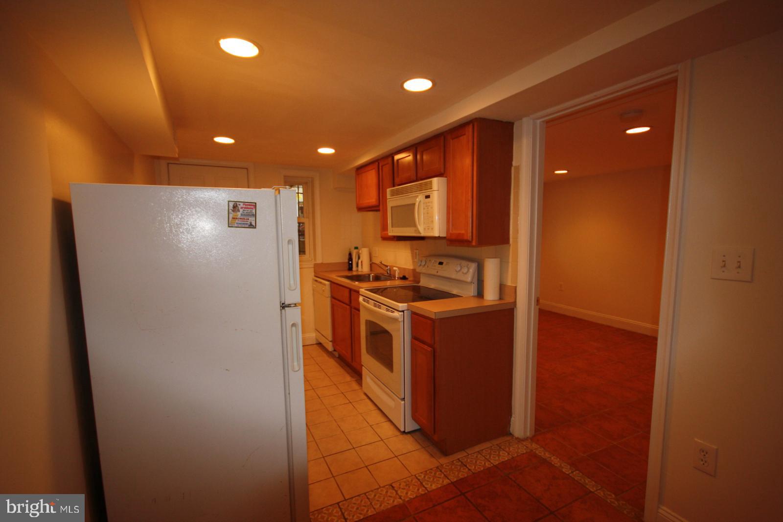 3607 11th Street Northwest, Unit B Washington, DC 20010 - Photo 4 of 16 a kitchen with kitchen island granite countertop cabinets and refrigerator