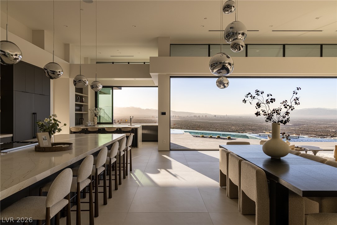 563 Grand Rim Drive Henderson, NV 89012 - Photo 8 of 70 Floor-to-ceiling glass reveals breathtaking panoramic desert and city vistas from this contemporary open-concept space.