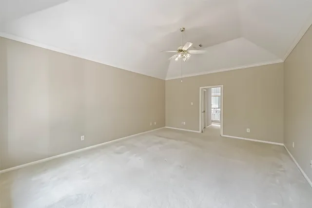 a view of an empty room with a ceiling fan