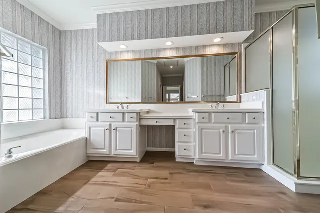 a spacious bathroom with a sink a mirror and a bathtub
