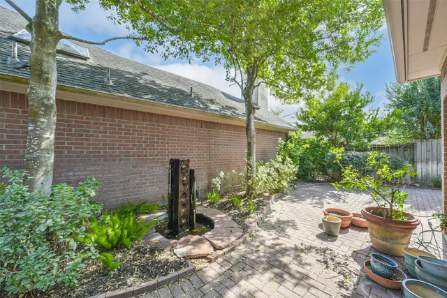 a backyard of a house with plants and outdoor seating