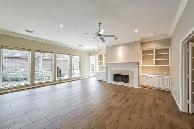 a view of an empty room with a fireplace and a window