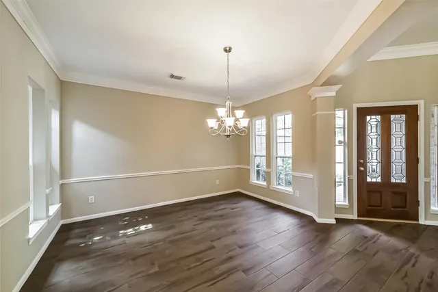 a view of a room with wooden floor and large window