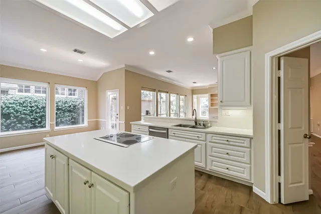 a kitchen with a sink stove and cabinets