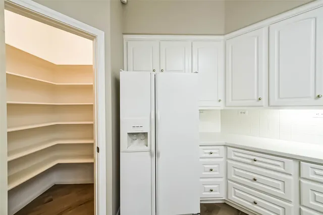 a kitchen with cabinets appliances and a window