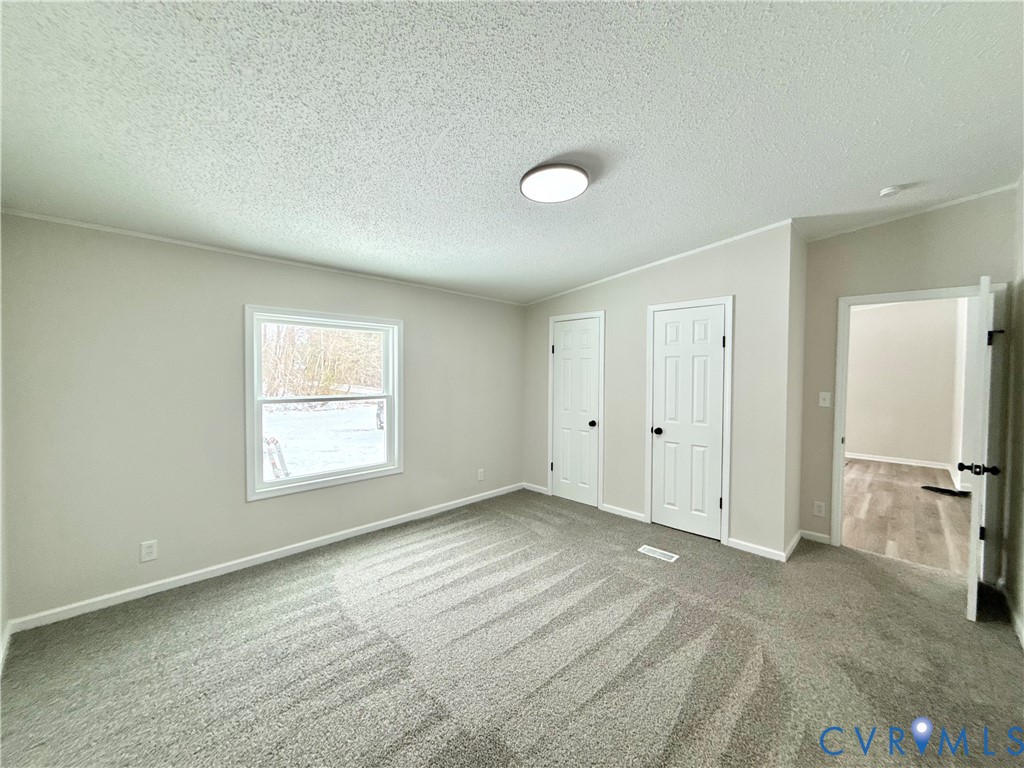 1500 Webster Road Glade Hill, VA 24092 - Photo 12 of 22 an empty room with a window and a kitchen