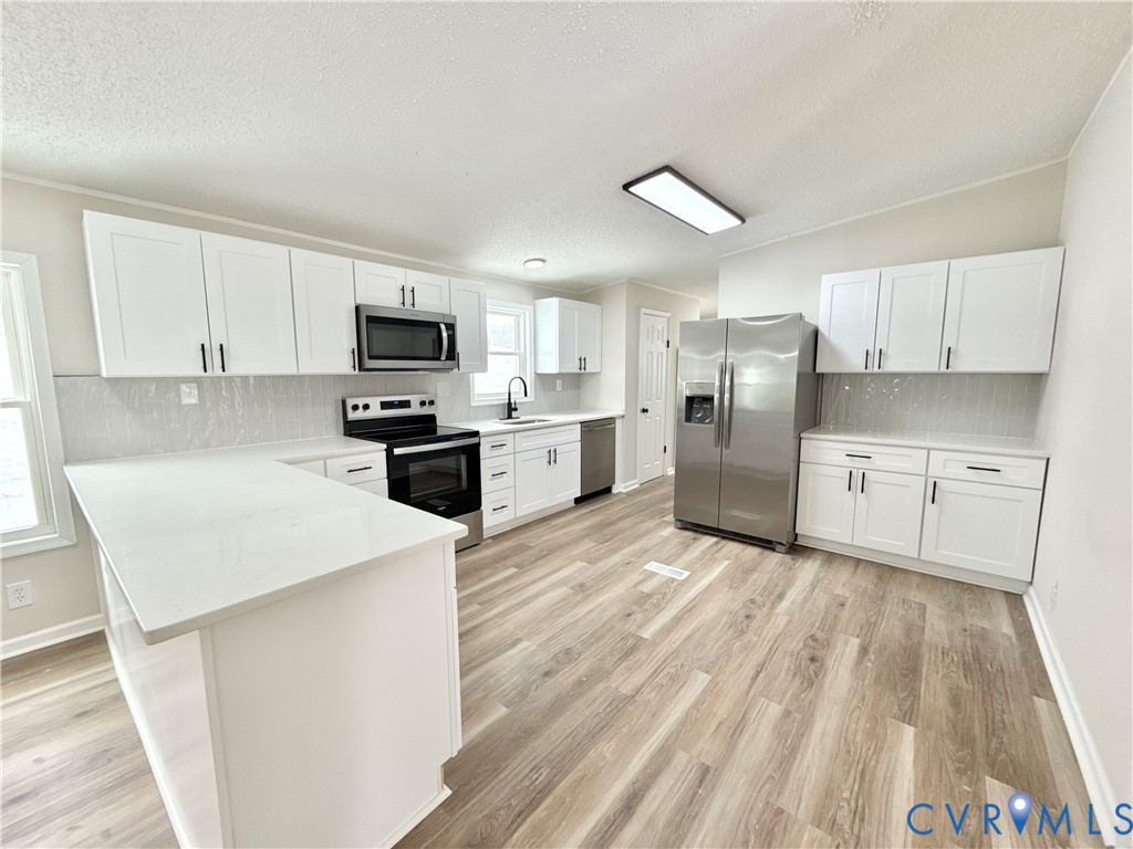 1500 Webster Road Glade Hill, VA 24092 - Photo 7 of 22 a kitchen with granite countertop a refrigerator stove top oven and sink