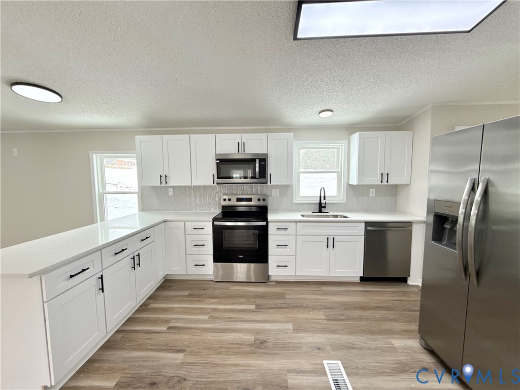 1500 Webster Road Glade Hill, VA 24092 - Photo 8 of 22 a kitchen with granite countertop white cabinets and stainless steel appliances
