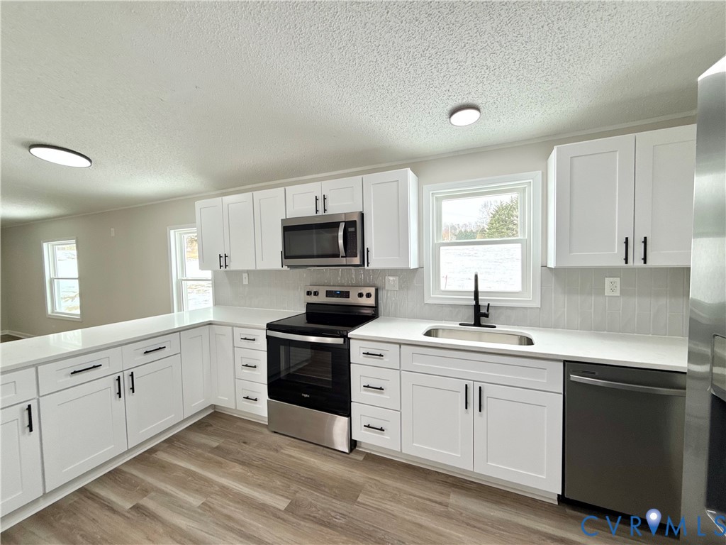 1500 Webster Road Glade Hill, VA 24092 - Photo 10 of 22 a kitchen with sink a microwave and cabinets