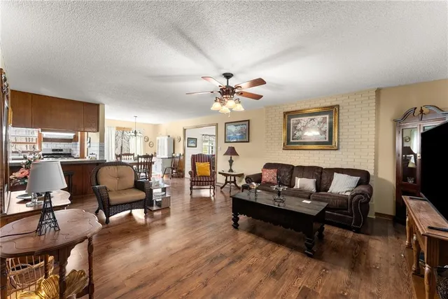 a dining room with furniture a chandelier and wooden floor