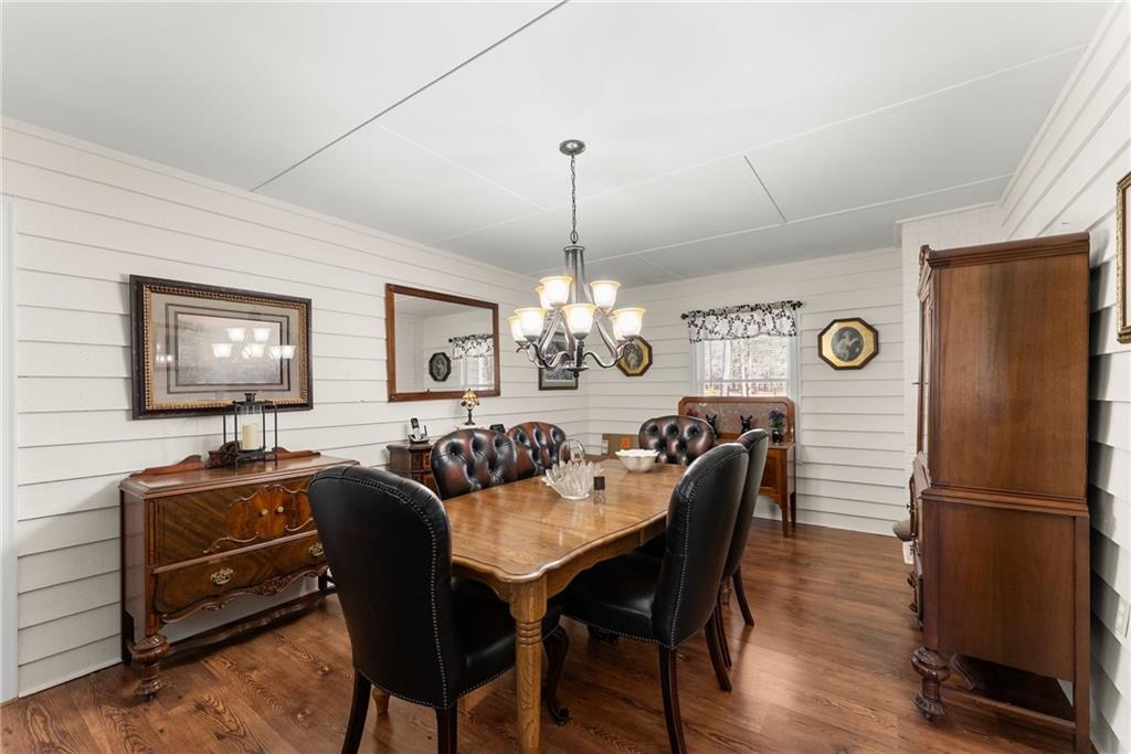 312 Ashley Brook Drive Lula, GA 30554 - Photo 15 of 62 a dining room with furniture a chandelier and wooden floor