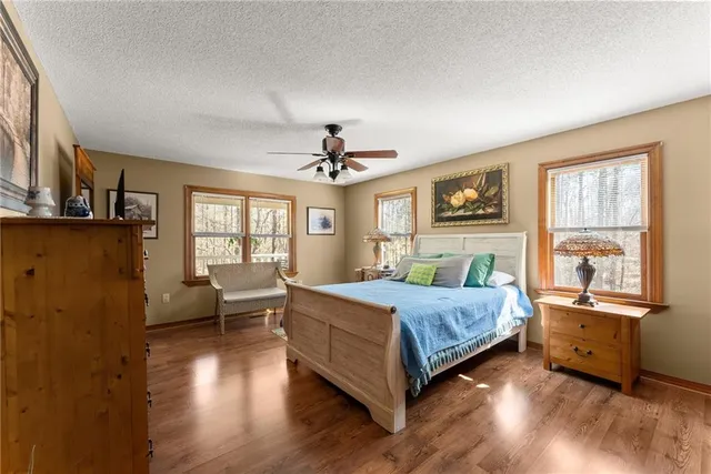 a bedroom with a bed a chair and a chandelier