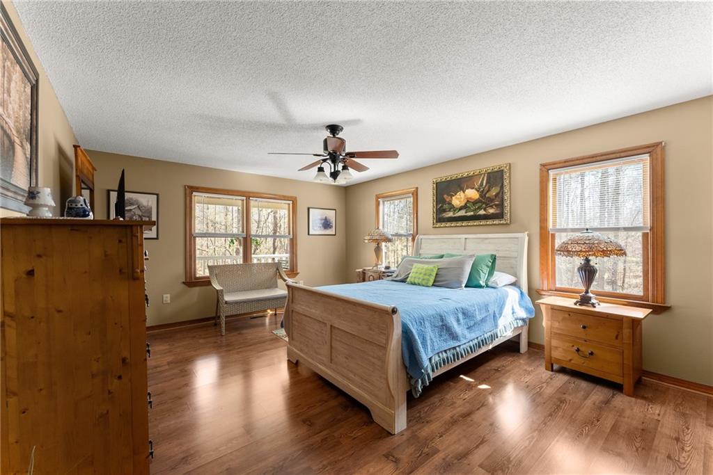 312 Ashley Brook Drive Lula, GA 30554 - Photo 25 of 62 a bedroom with a bed couch and windows