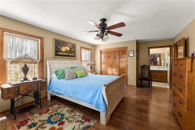 a bathroom with a granite countertop sink mirror and a toilet