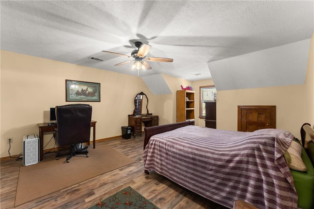 312 Ashley Brook Drive Lula, GA 30554 - Photo 28 of 62 a bedroom with a bed a chair and a chandelier