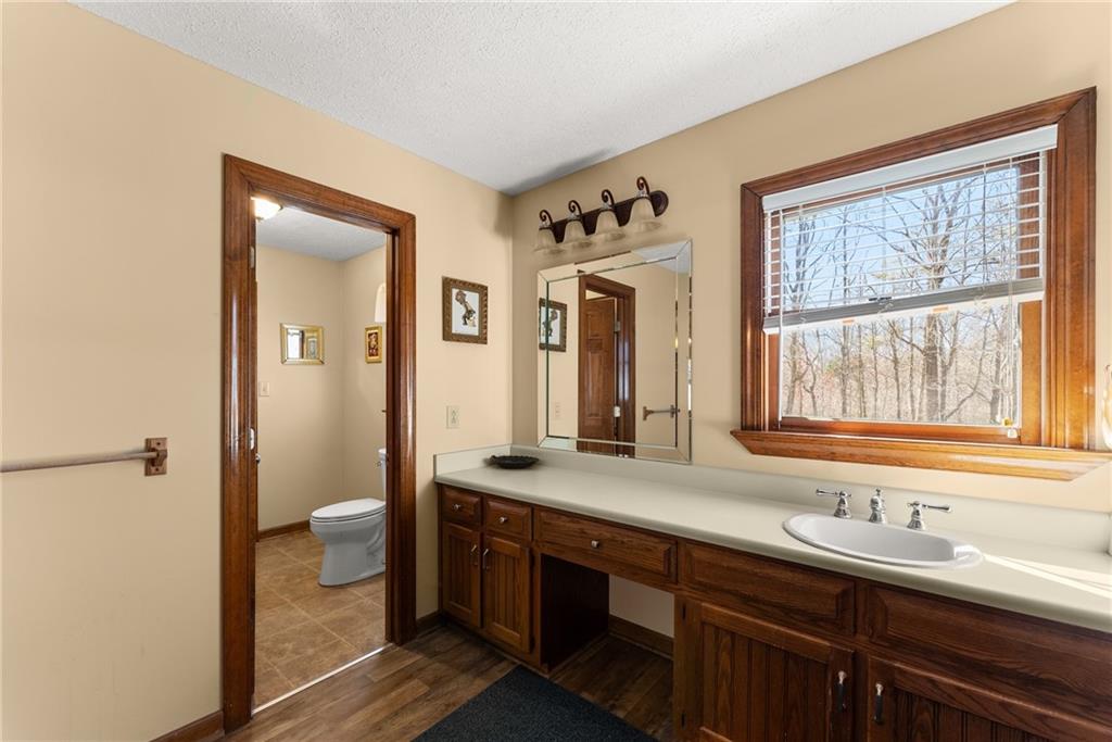 312 Ashley Brook Drive Lula, GA 30554 - Photo 30 of 62 a bathroom with a granite countertop sink mirror and a toilet