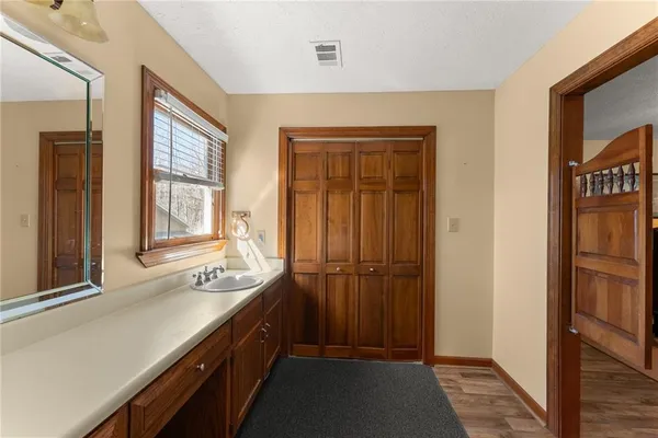 a living room with furniture two window and a flat screen tv