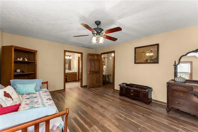 a living room with furniture and floor to ceiling window