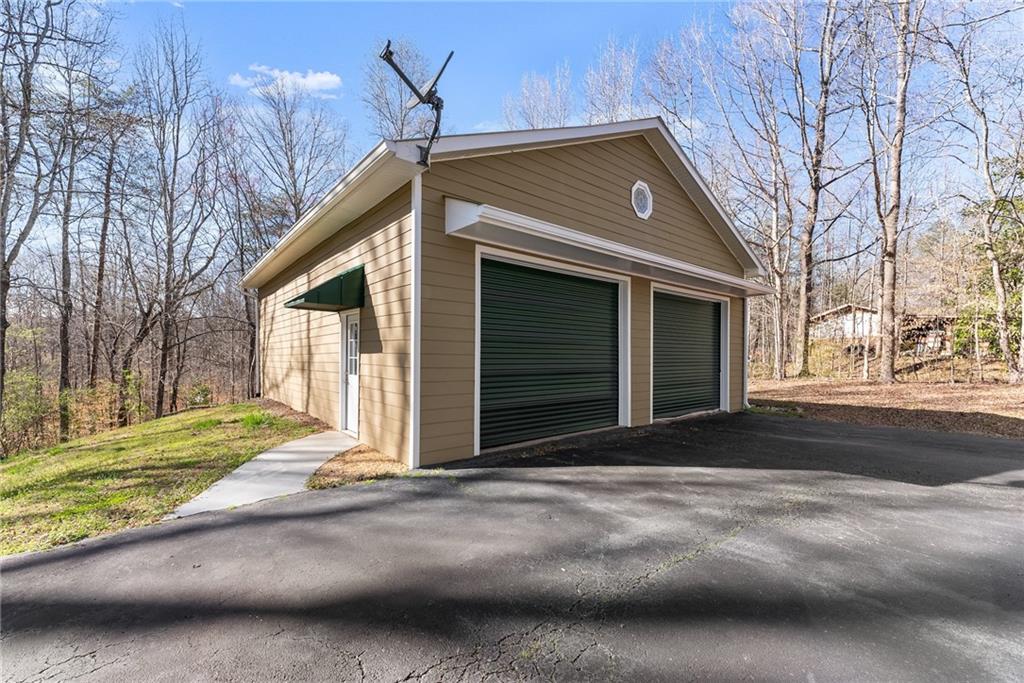 312 Ashley Brook Drive Lula, GA 30554 - Photo 47 of 62 a front view of a house with a yard and garage
